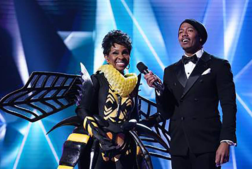 The Bee is revealed as Gladys Knight during "The Masked Singer." With Knight is host Nick Cannon. (Fox)