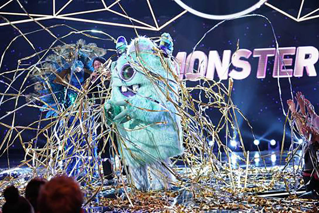 The Monster and host Nick Cannon are seen in "The Masked Singer." (Fox)