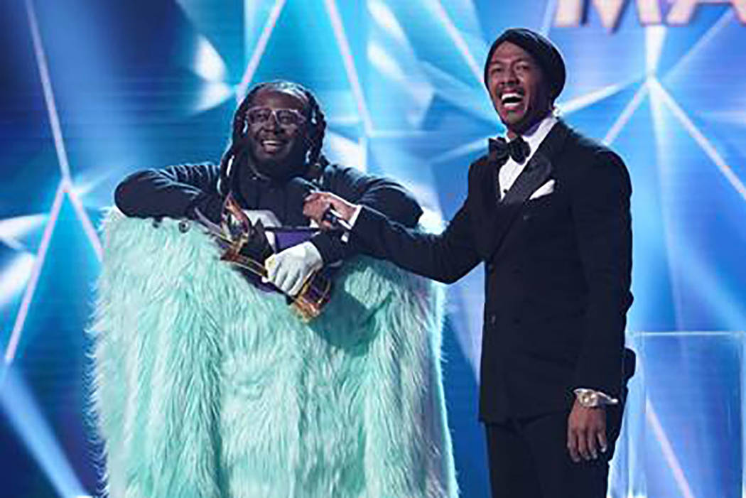 The Monster is revealed as T-Pain during "The Masked Singer." With T-Pain is host Nick Cannon. (Fox)