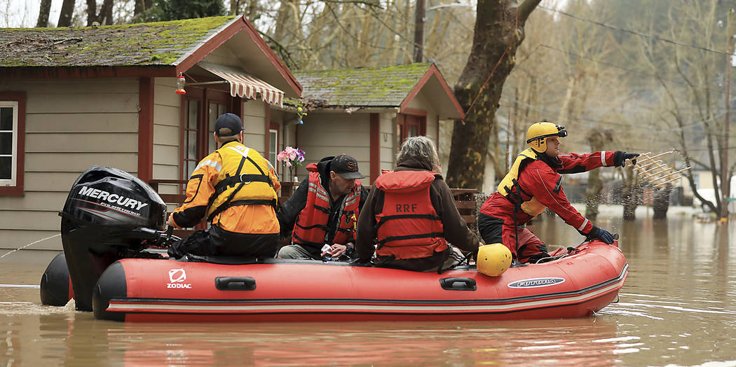Ryan Lance, front, and Anthony Nash of the Russian River Fire Protection District swift-water rescue team rescue residents of Sycamore Court Apartment Wednesday, Feb. 27, 2019, in lower Guernevill ...