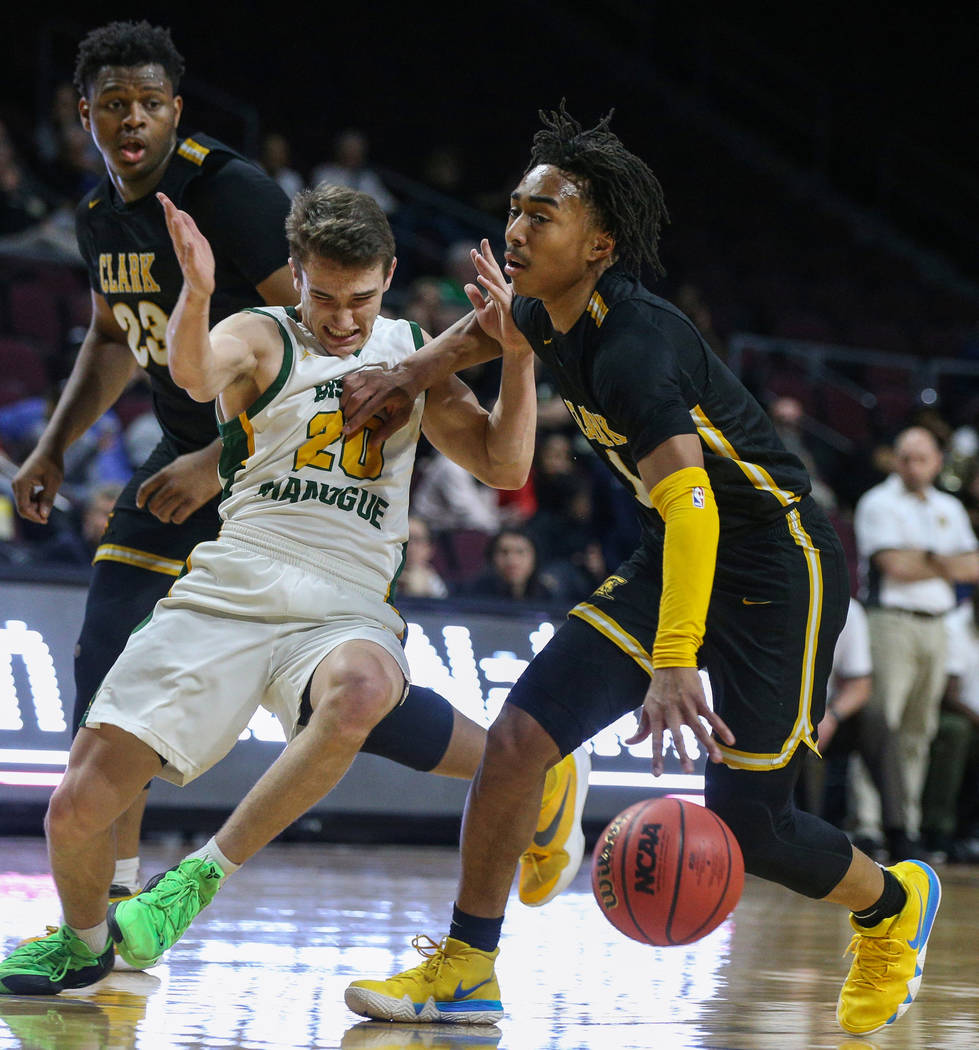 Clark's Frankie Collins (1) pushes back Bishop Manogue's Cort Ballinger (20) as Clark's Antwon Jackson (23) looks on during the first half of a Class 4A state boys basketball semifinal game at the ...