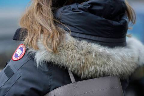 In this Feb. 14, 2019 photo, a woman in New York wears a Canada Goose coat with a hood fur trimmed with coyote fur. Coyote pelts are in big demand to provide the lush, tawny-tinged arc of fur on t ...
