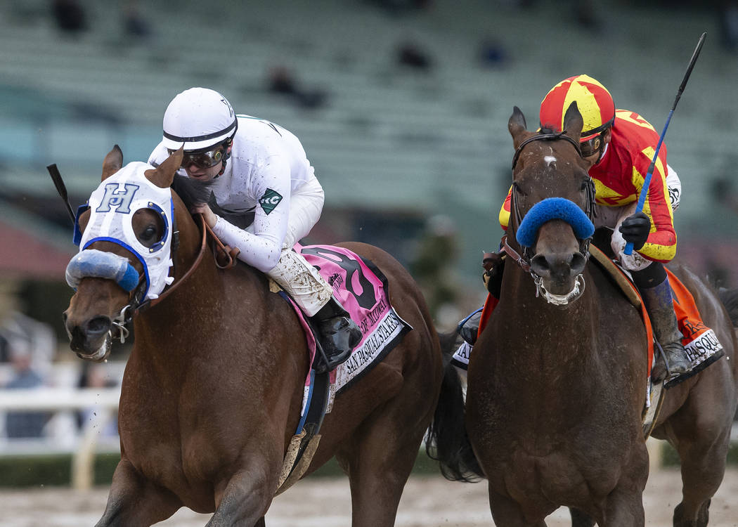 In a photo provided by Benoit Photo, Battle of Midway and jockey Flavien Prat, left, outleg McKinzie, with Mike Smith, to win the Grade II, $200,000 San Pasqual Stakes horse race Saturday, Feb. 2, ...