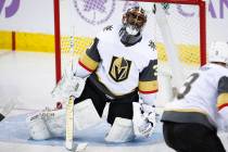 Vegas Golden Knights goalie Malcolm Subban, left, reacts after letting in a goal during second period NHL hockey action against the Calgary Flames in Calgary, Alberta, Monday, Nov. 19, 2018. (Jeff ...