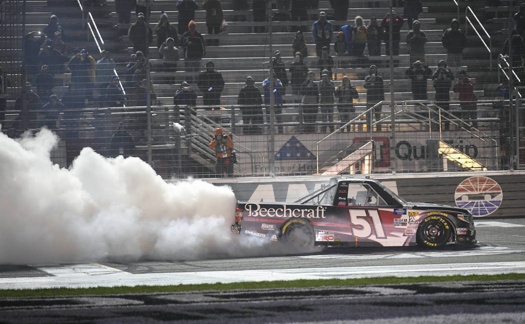 Kyle Busch does a burnout after winning the NASCAR Truck Series auto race at Atlanta Motor Speedway, Saturday, Feb. 23, 2019, in Hampton, Ga. (AP Photo/John Amis)