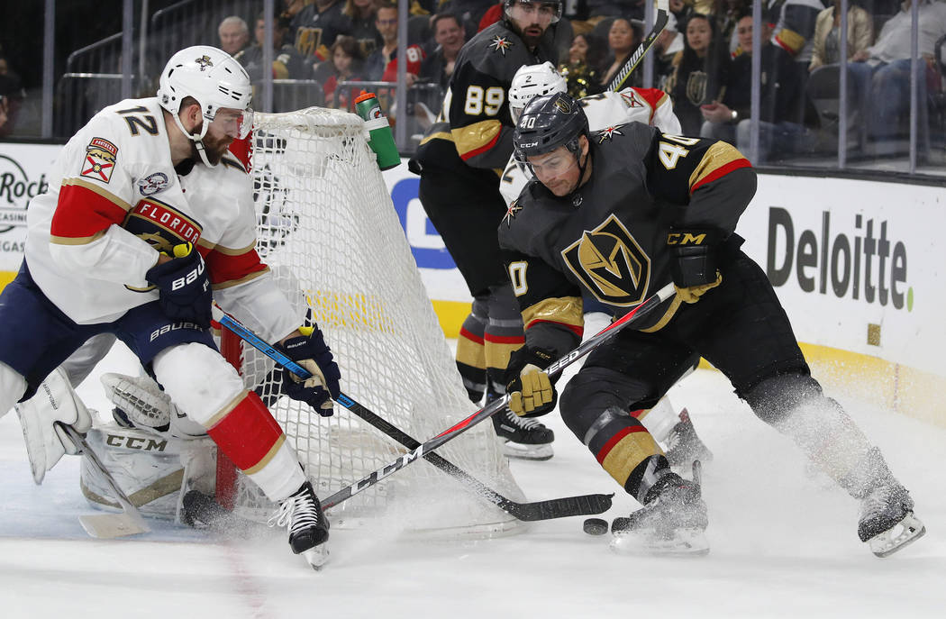 Florida Panthers defenseman Ian McCoshen (12) knocks the puck away from Vegas Golden Knights center Ryan Carpenter (40) during the second period of an NHL hockey game Thursday, Feb. 28, 2019, in L ...