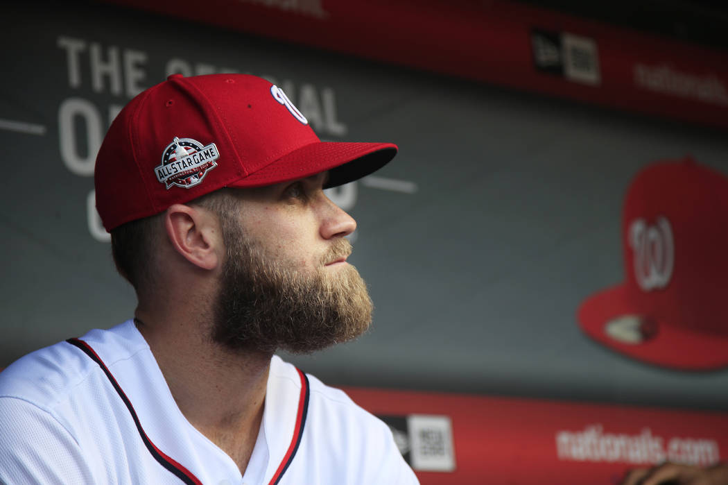 FILE - In this Sept. 26, 2018, file photo, Washington Nationals' Bryce Harper, looks at the baseball field from their dug out before the start of the Nationals last home game of the season against ...