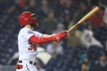 Washington Nationals Bryce Harper (34) follows the ball as he hits his 100th RBI during the fourth inning of a baseball game against the Miami Marlins in Washington, Monday, Sept. 24, 2018. (AP Ph ...
