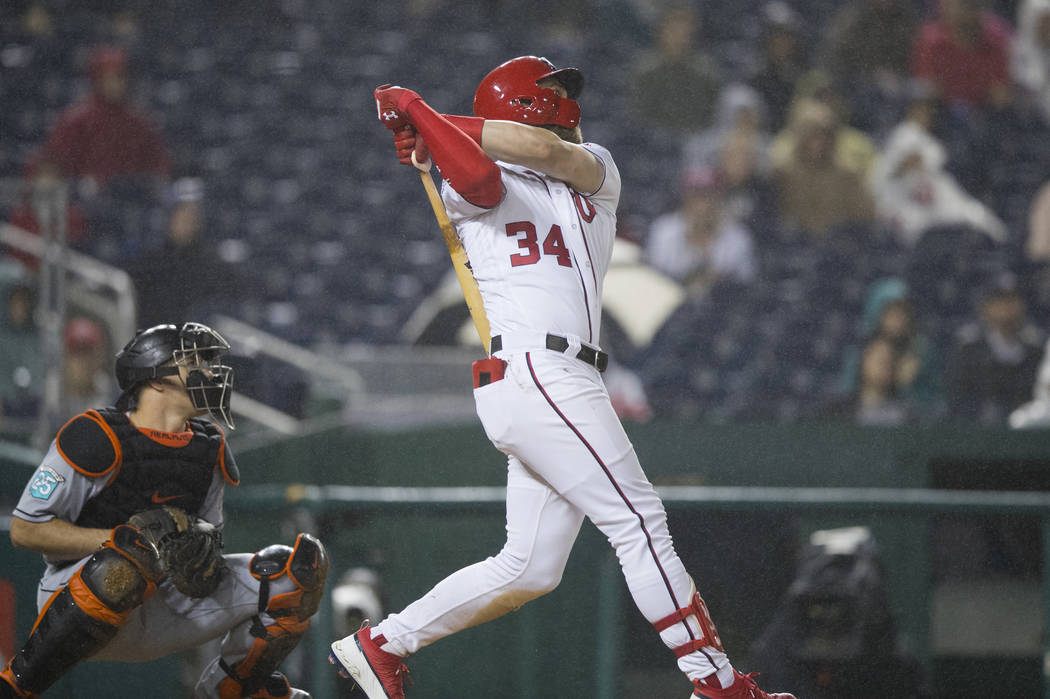 Washington Nationals Bryce Harper (34) follows the ball as he hits his 100th RBI, during the fourth inning of a baseball game against the Miami Marlins in Washington, Monday, Sept. 24, 2018. (AP P ...