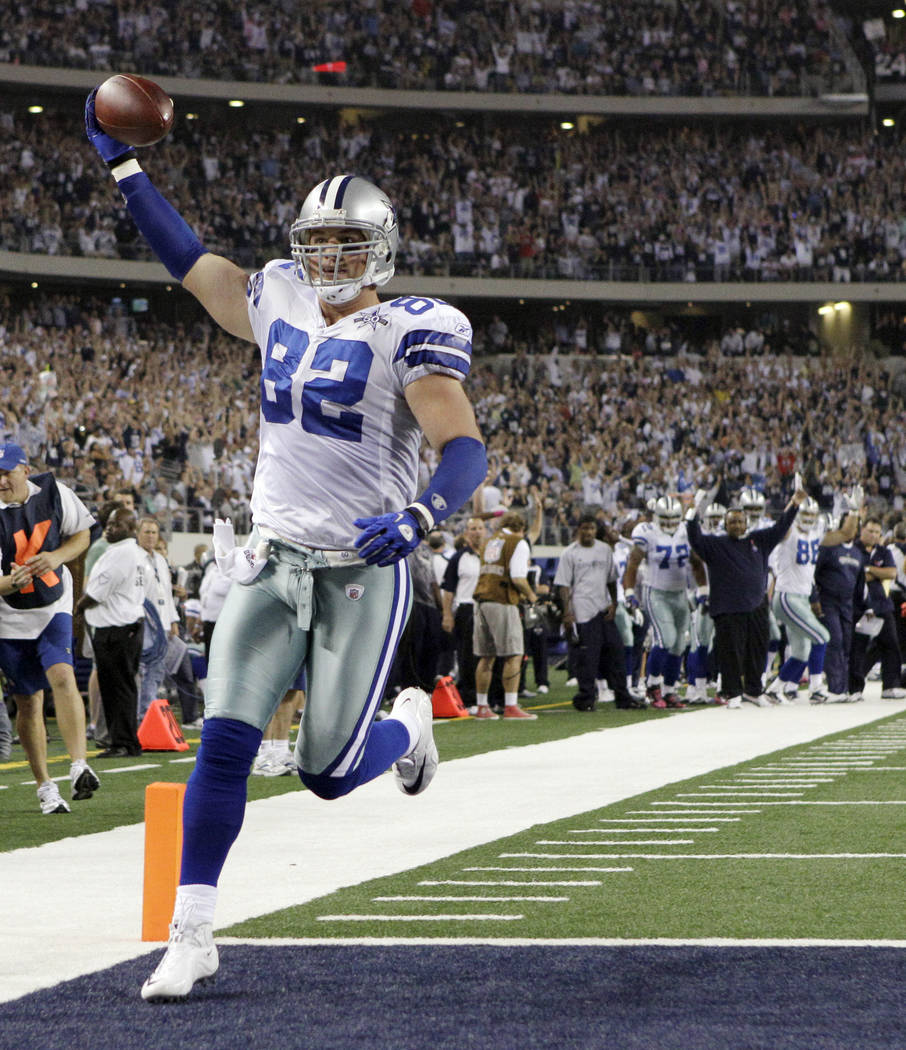 FILE - In this Oct. 25, 2010, file photo, Dallas Cowboys tight end Jason Witten holds the ball up as he scores a 4-yard touchdown against the New York Giants during the first quarter of an NFL foo ...