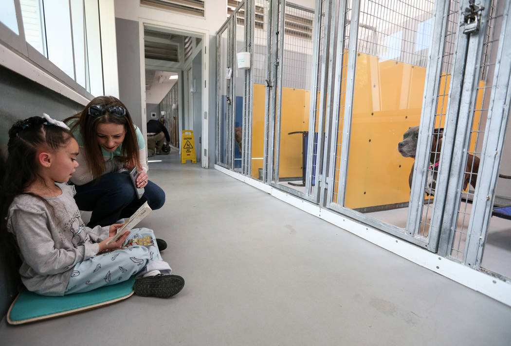 First-grader Isabella Rodriguez, 6, and her mother, Kristina Rodriguez, participate in the 4th Annual "Reading to Dogs in Kennels" event at The Animal Foundation during Nevada Reading Week in Las ...