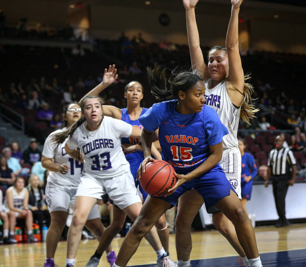 Bishop Gorman's Asya Bey (15) protects the ball while being guarded by Spanish Springs' Lauryn Dressler (20) during the first half of a Class 4A state girls basketball semifinal game at the Orlean ...