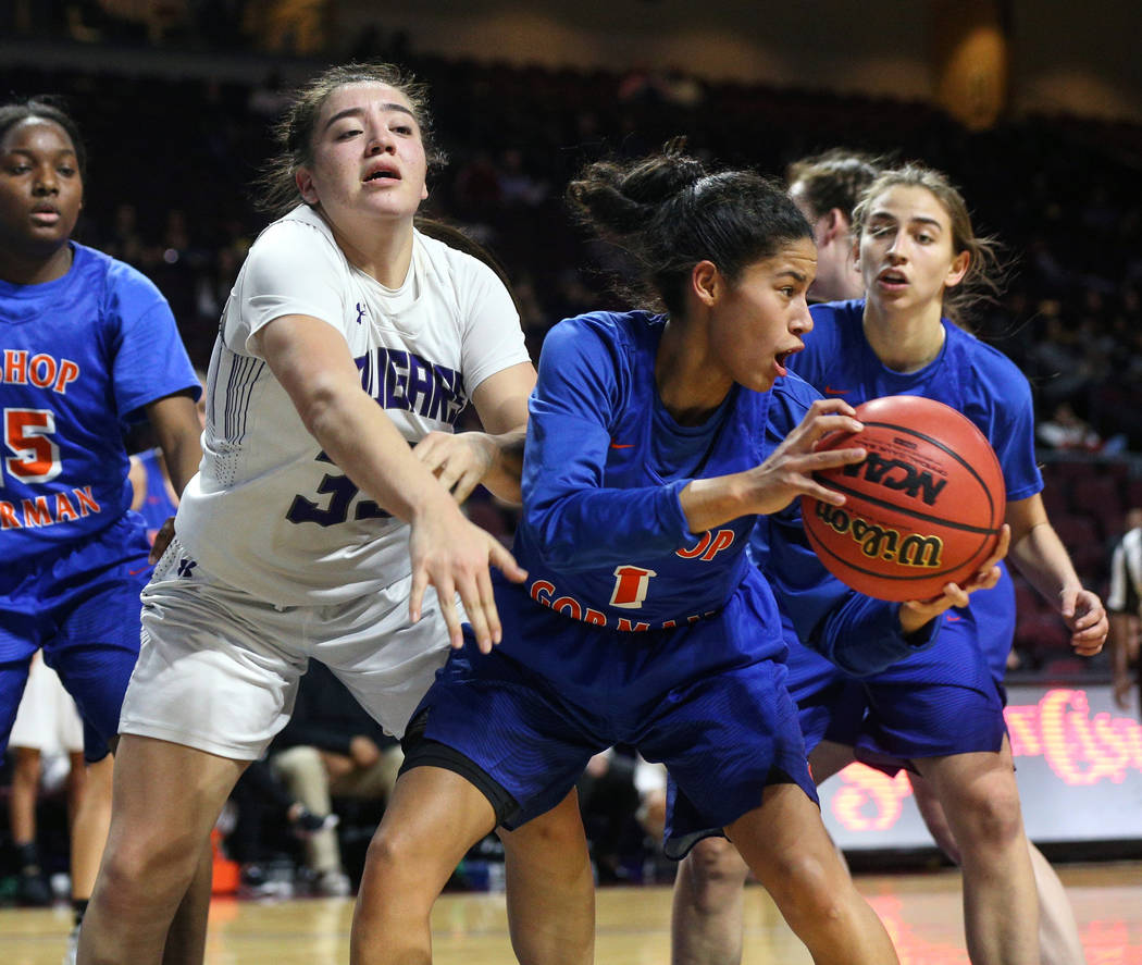 Bishop Gorman's Caira Young (1) protects the ball while being guarded by Spanish Springs' Mariah Barraza (33) during the second half of a Class 4A state girls basketball semifinal game at the Orle ...