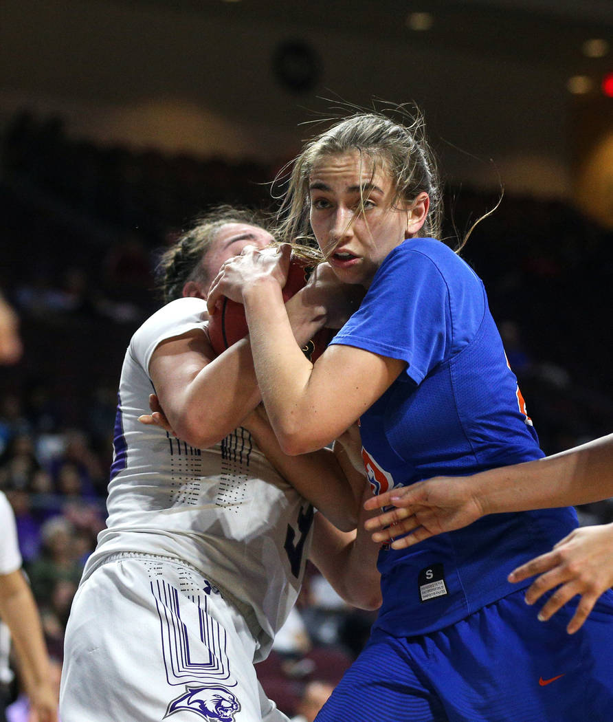 Bishop Gorman's Alexis Kruljac (22) fights for the ball against Spanish Springs' Mariah Barraza (33) during the second half of a Class 4A state girls basketball semifinal game at the Orleans Arena ...