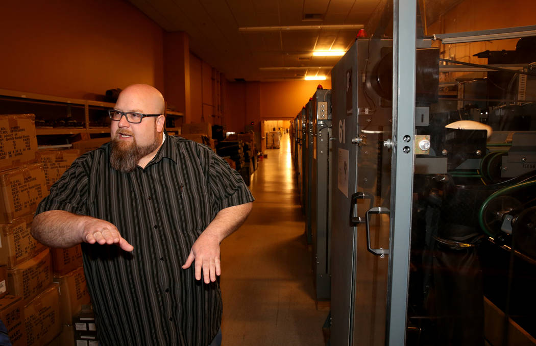 Red Rock Lanes Bowling Operations Manager Dennis Mathews talks to a reporter in the pin setting ...