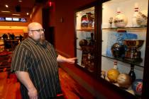 Red Rock Lanes Bowling Operations Manager Dennis Mathews shows the trophy case featuring major ...