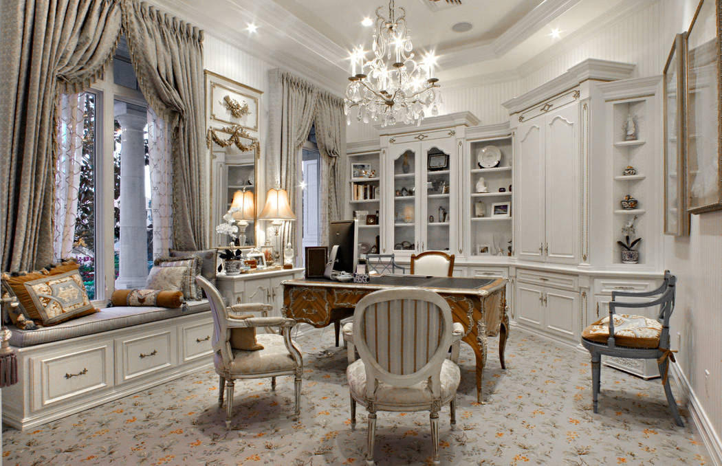This home office belongs to a woman who loves the traditional French style. The classic French ormolu desk, which sits on a traditional French custom-made carpet, is the centerpiece of the room. ( ...