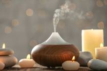 An aroma oil diffuser and candles are used to inject scent into a home. (Getty)