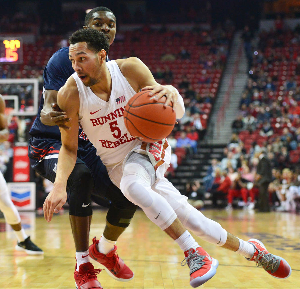 UNLV Rebels guard Noah Robotham (5) dribbles the ball around the edge during the first half of a game between UNLV and Fresno State at the Thomas & Mack Center in Las Vegas, on Saturday, Feb. ...