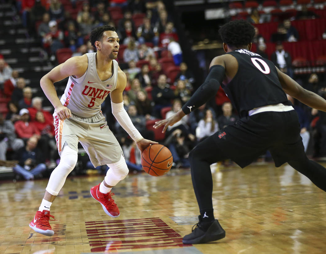 UNLV Rebels guard Noah Robotham (5) drives the ball around San Diego State Aztecs guard Devin Watson (0) during the second half of a basketball game at the Thomas & Mack Center in Las Vegas on ...