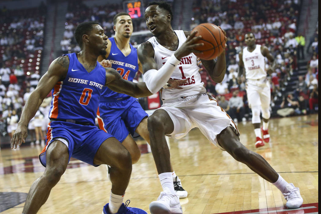 UNLV Rebels guard Kris Clyburn (1) drives to the basket against Boise State Broncos guard Marcus Dickinson (0) during the first half of a basketball game at the Thomas & Mack Center in Las Veg ...