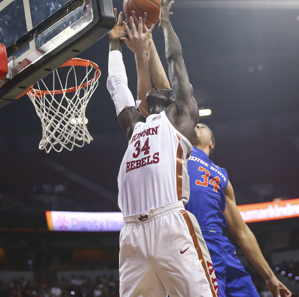 UNLV Rebels forward Cheikh Mbacke Diong, left, and Boise State Broncos guard Alex Hobbs battle for a rebound during the first half of a basketball game at the Thomas & Mack Center in Las Vegas ...