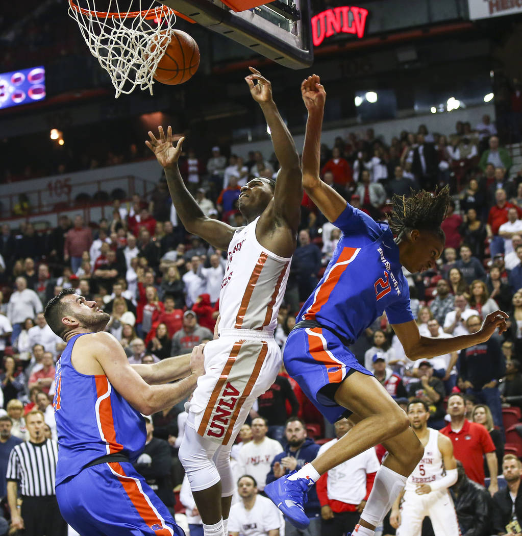 UNLV Rebels guard Amauri Hardy (3) gets fouled by Boise State Broncos guard Derrick Alston (21) during the second half of a basketball game at the Thomas & Mack Center in Las Vegas on Saturday ...