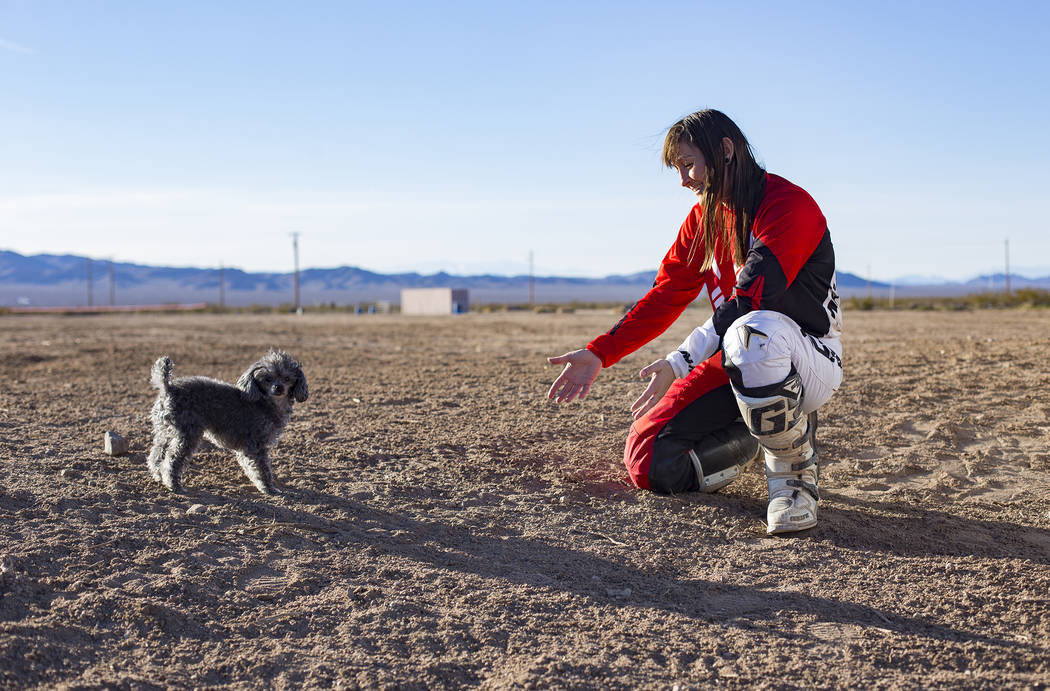 Angie Wright plays with her dog, Phoenix, at Western Raceway track outside White Hills, Arizona, Sunday, Feb. 24, 2019. Wright will be racing in the Mint 400's motorcycle race, the first dirt bike ...