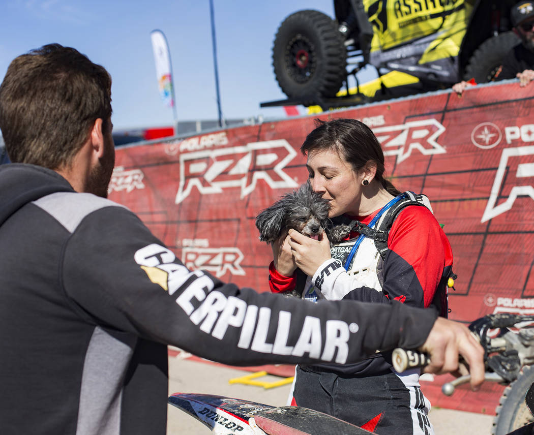 Angie Wright kisses her dog Phoenix after completing the Mint 400 motorcycle race in Primm, Nevada, Saturday, March 9, 2019. She completed in the amateur ironman class, riding 164 miles alone with ...