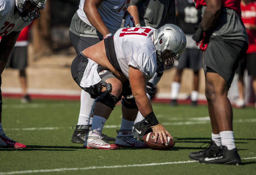 UNLV center Zack Singer prepares to snap the ball while practicing a play during training camp at Rebel Park on Tuesday, Aug. 8, 2017. Patrick Connolly Las Vegas Review-Journal @PConnPie