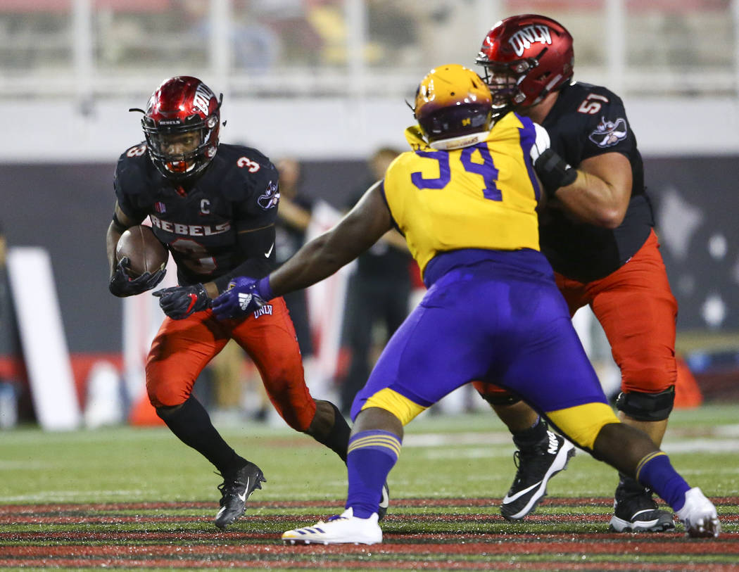 UNLV Rebels running back Lexington Thomas (3) runs the ball past Prairie View A&M Panthers defensive lineman Jermaine Jackson (94) in front of UNLV Rebels offensive lineman Zack Singer (51) du ...