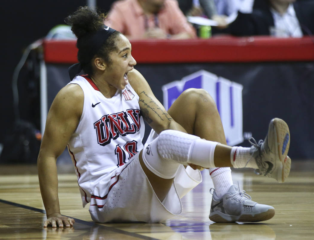 UNLV Lady Rebels guard Nikki Wheatley (10) reacts after an injury during overtime in a basketball game against the UNR Wolf Pack in the Mountain West tournament quarterfinals at the Thomas & M ...
