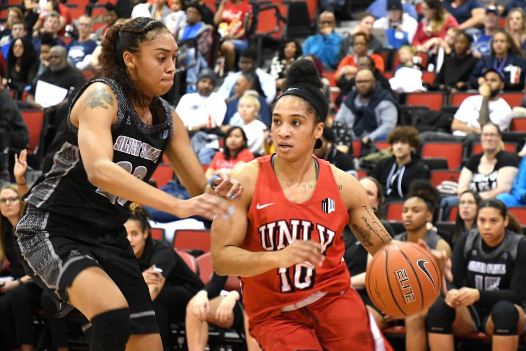 UNLV point guard Nikki Wheatley drives against UNR on Feb. 27 at Cox Pavilion. Photo by Mark Newman.
