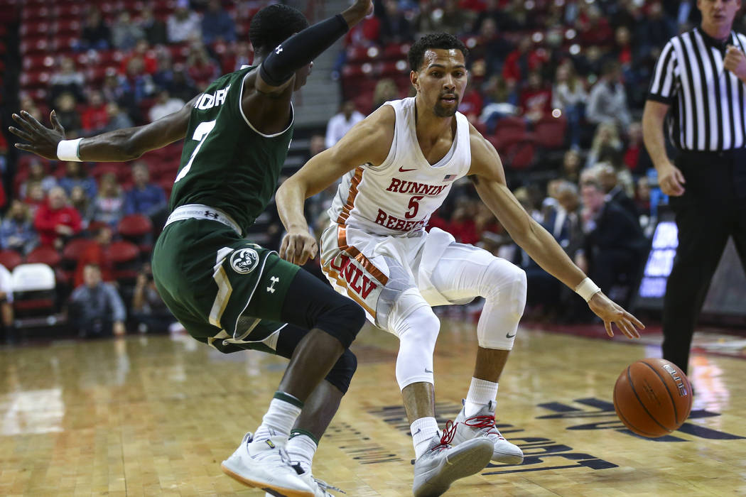 UNLV Rebels guard Noah Robotham (5) brings the ball up court against Colorado State guard Kendle Moore during the first half of a basketball game at the Thomas & Mack Center in Las Vegas on We ...