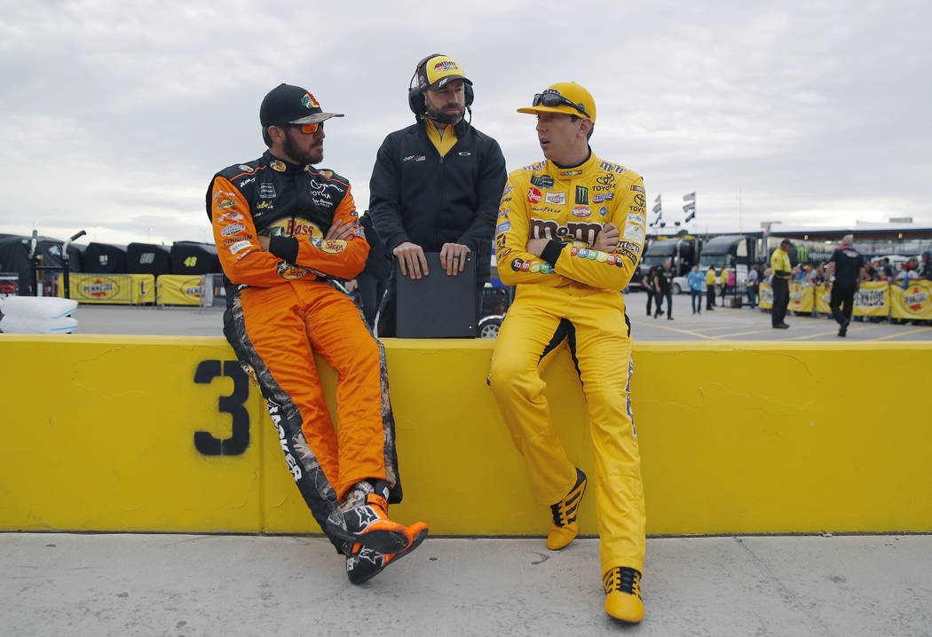 Martin Truex Jr., left, and Kyle Busch, right, talk before qualifying for a NASCAR Cup Series auto race at the Las Vegas Motor Speedway, Friday, March 1, 2019, in Las Vegas. (AP Photo/John Locher)