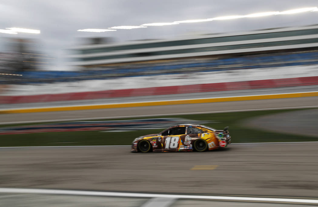 Kyle Busch (18) drives down pit lane during qualifying for the NASCAR Cup Series auto race at Las Vegas Motor Speedway, Friday, March 1, 2019, in Las Vegas. (AP Photo/John Locher)