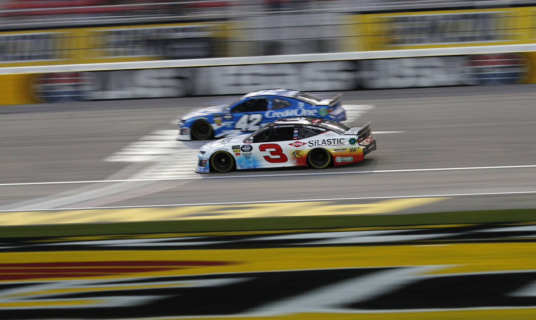 Austin Dillon (3) and Kyle Larson (42) drive during qualifying for a NASCAR Cup Series auto race at the Las Vegas Motor Speedway, Friday, March 1, 2019, in Las Vegas. (AP Photo/John Locher)