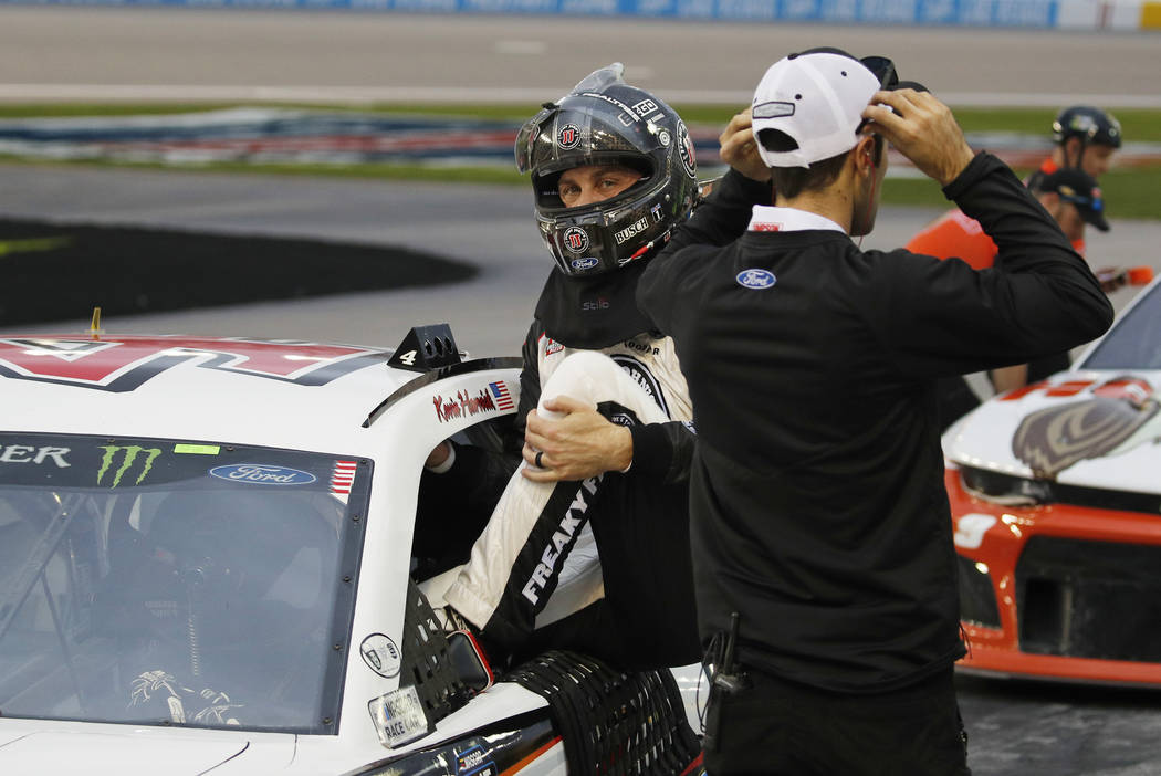 Kevin Harvick gets out of his car after winning the pole position during qualifying for a NASCAR Cup Series auto race at the Las Vegas Motor Speedway, Friday, March 1, 2019, in Las Vegas. (AP Phot ...
