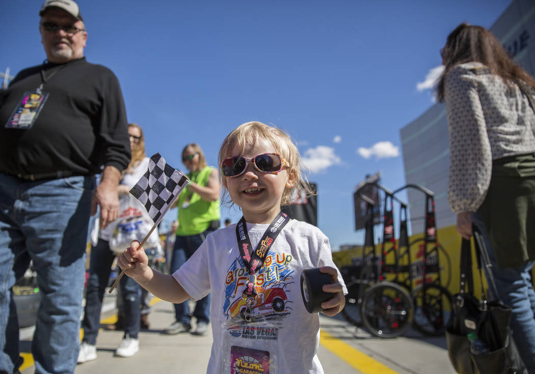 Jazz Lapare-Guzman, 4, waves her flag on pit row before the start of the Monster Energy NASCAR Cup Series Pennzoil 400 on Sunday, March 3, 2019, at Las Vegas Motor Speedway, in Las Vegas. (Benjami ...