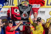 Joey Logano, right, and Carlos Maurer, president of Shell Lubricants Americas, hold the first place trophy after Logano won the Monster Energy NASCAR Cup Series Pennzoil 400 on Sunday, March 3, 2 ...