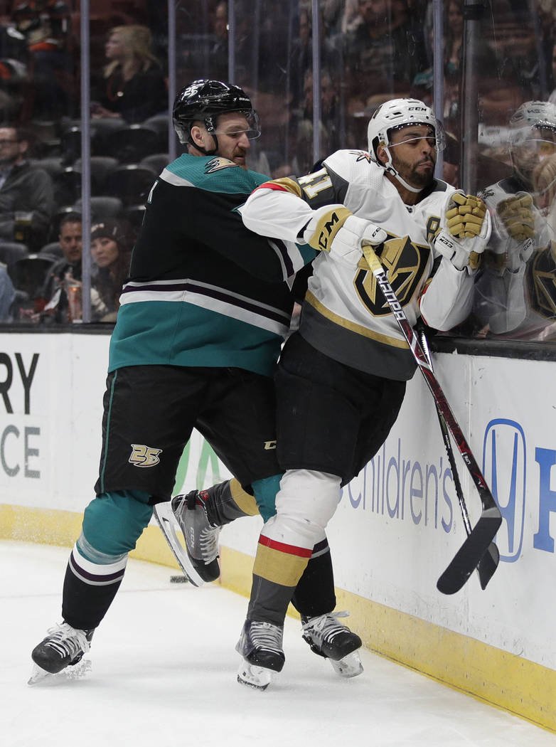 Anaheim Ducks' Korbinian Holzer, left, shoves Vegas Golden Knights' Pierre-Edouard Bellemare during the first period of an NHL hockey game Friday, March 1, 2019, in Anaheim, Calif. (AP Photo/Jae C ...