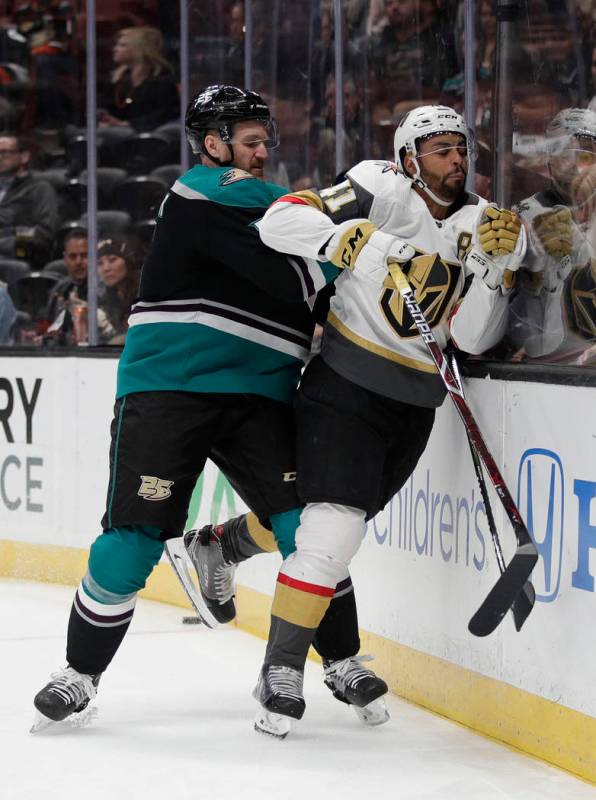 Anaheim Ducks' Korbinian Holzer, left, shoves Vegas Golden Knights' Pierre-Edouard Bellemare during the first period of an NHL hockey game Friday, March 1, 2019, in Anaheim, Calif. (AP Photo/Jae C ...