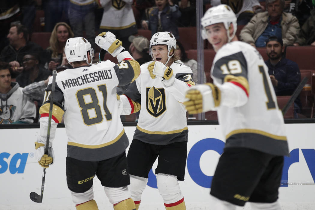 Vegas Golden Knights' William Karlsson, center, celebrates his goal with Jonathan Marchessault during the first period of the team's NHL hockey game against the Anaheim Ducks on Friday, March 1, 2 ...