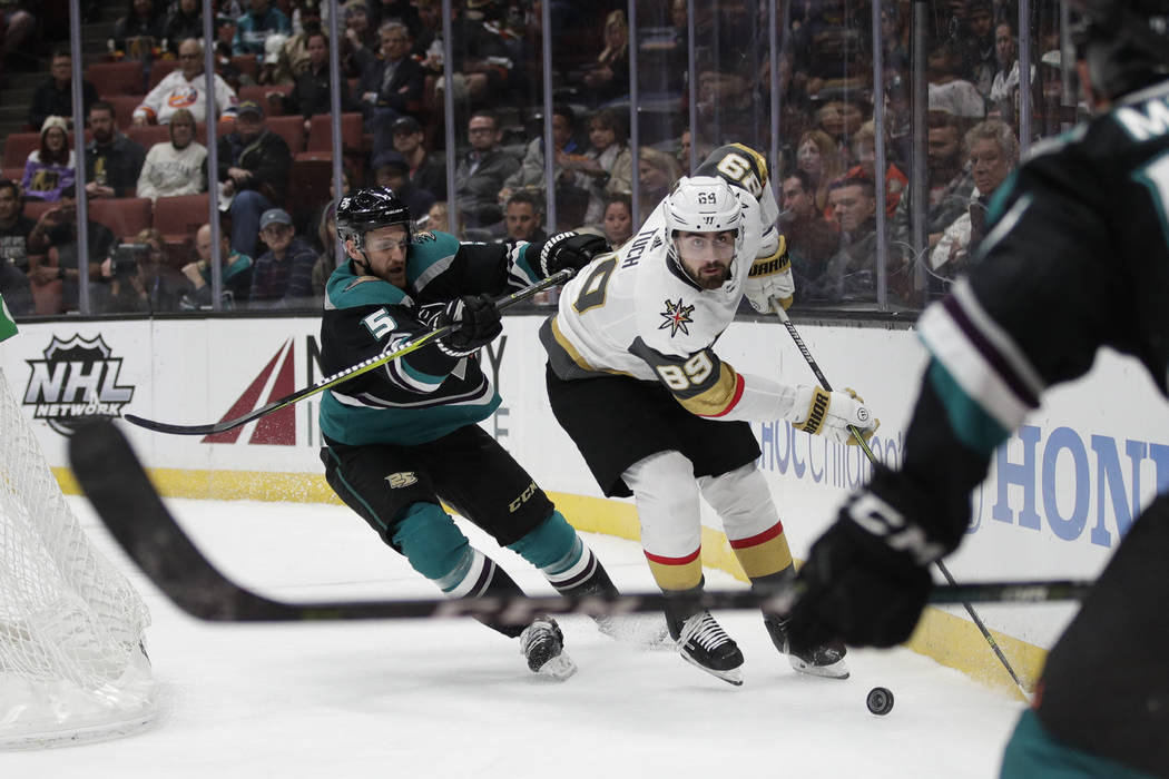 Vegas Golden Knights' Alex Tuch, right rear, moves the puck past Anaheim Ducks' Korbinian Holzer during the first period of an NHL hockey game Friday, March 1, 2019, in Anaheim, Calif. (AP Photo/J ...