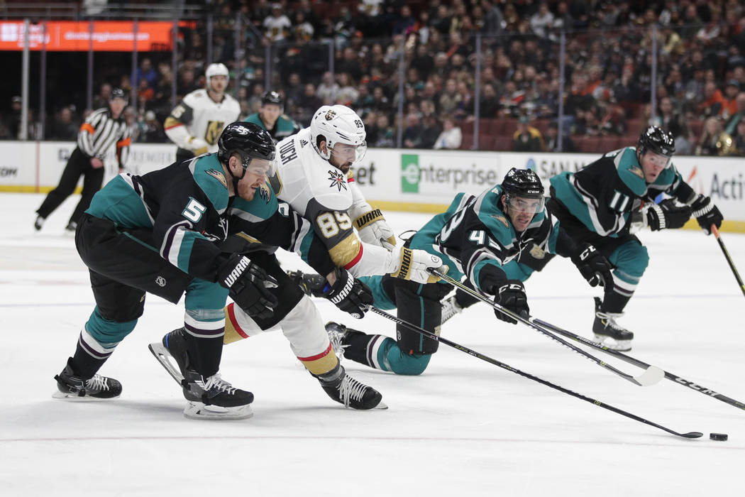 Vegas Golden Knights' Alex Tuch (89) fights for the puck with Anaheim Ducks' Korbinian Holzer (5) and Jaycob Megna (43) during the first period of an NHL hockey game Friday, March 1, 2019, in Anah ...