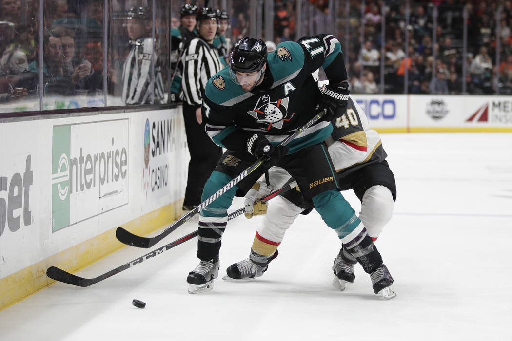 Anaheim Ducks' Ryan Kesler, front, moves the puck under pressure from Vegas Golden Knights' Ryan Carpenter during the second period of an NHL hockey game Friday, March 1, 2019, in Anaheim, Calif. ...
