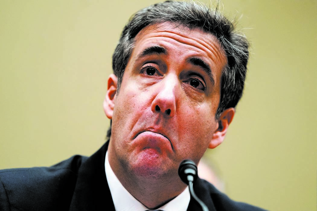 Michael Cohen, President Donald Trump's former personal lawyer, reads an opening statement as he testifies before the House Oversight and Reform Committee on Capitol Hill in Washington, Wednesday, ...
