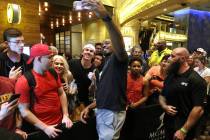 UFC light heavyweight champion Jon Jones holds up a cell phone to take a picture with a fan at UFC 235 open workouts at the MGM Grand hotel-casino in Las Vegas, Thursday, Feb. 28, 2019. (Heidi Fan ...