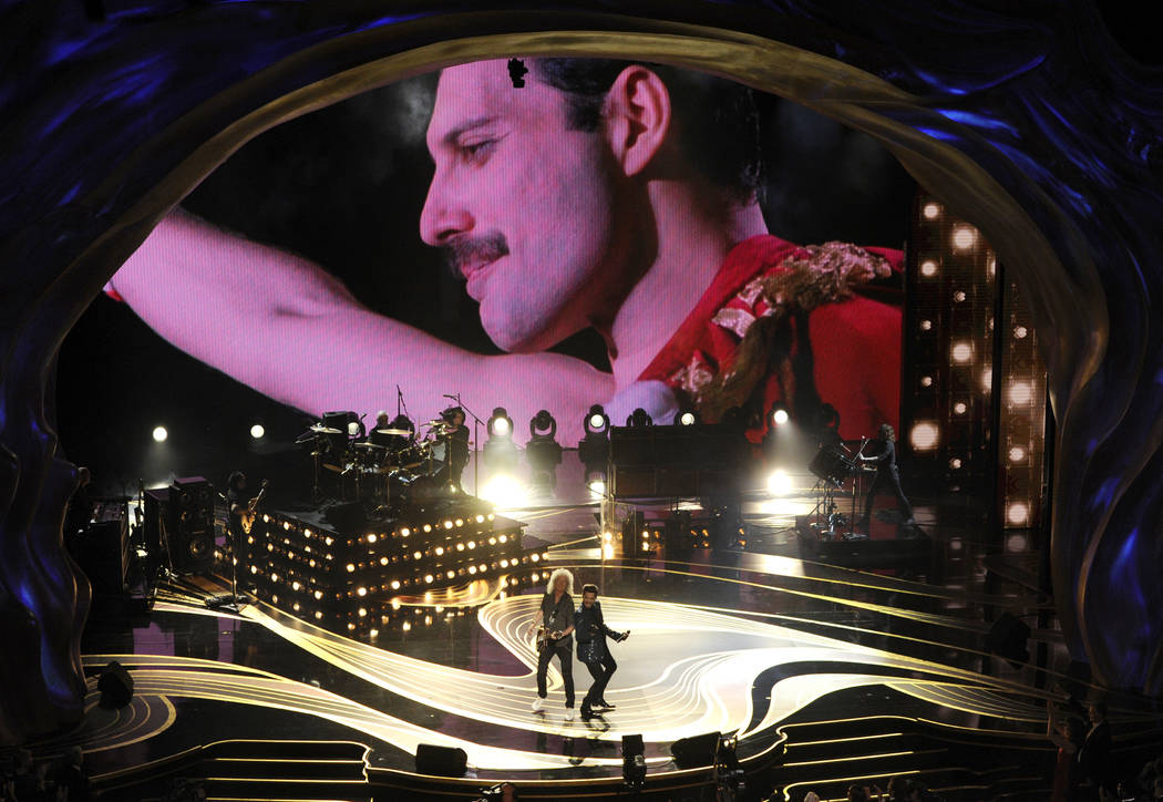 An image of Freddie Mercury appears on screen as Brian May, left, and Adam Lambert of Queen perform at the Oscars on Sunday, Feb. 24, 2019, at the Dolby Theatre in Los Angeles. (Photo by Chris Piz ...