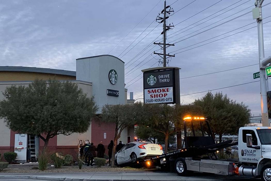 A car crashed into the wall of a Starbucks in its drive-thru lane at Sahara Avenue and Paradise Road, Friday, March 1, 2019. (Jessica Terrones/Las Vegas Review-Journal)